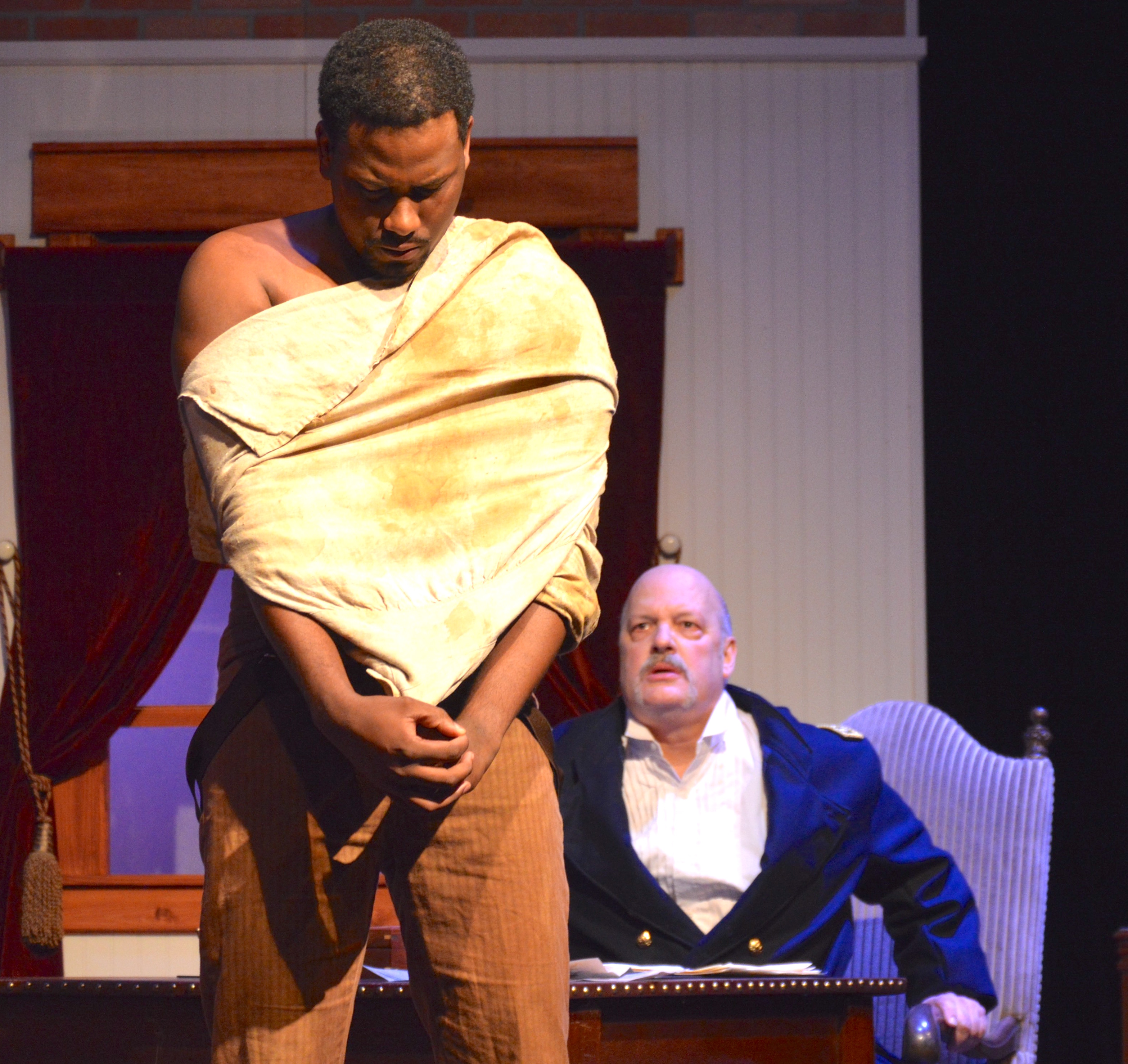 Shepard Mallory, played by Sharif Ali, shows Butler, played by Michael Mendonsa, scars from being whipped.
