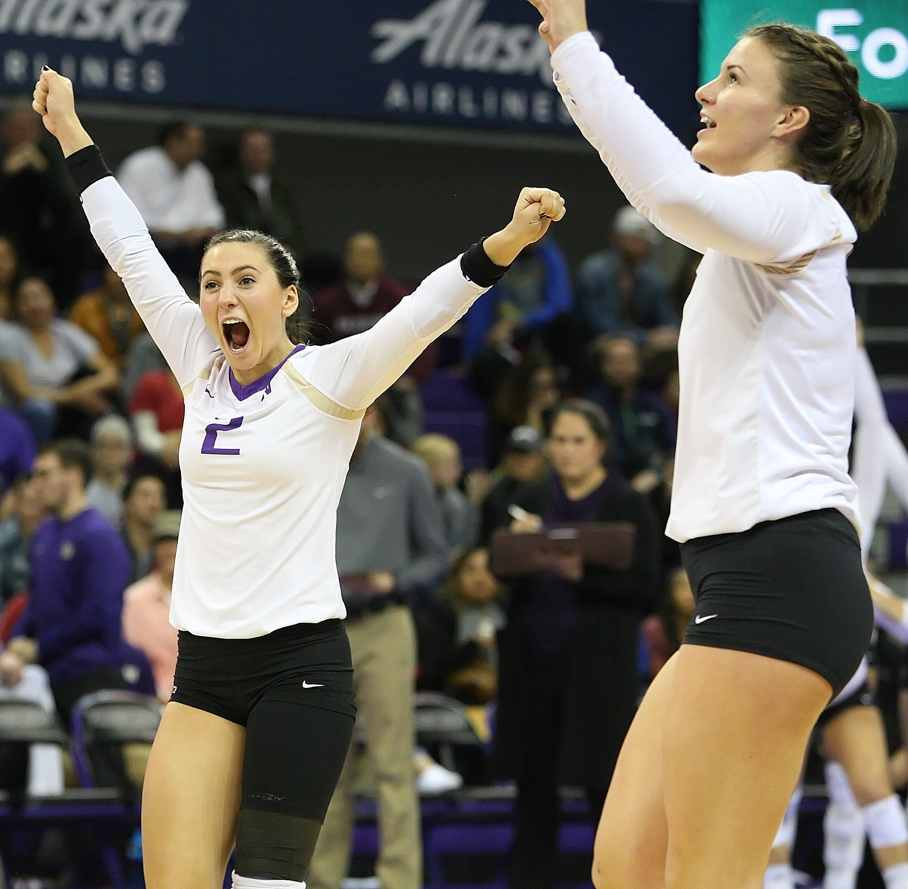 Shayne McPherson (left) of Washington shows her excitement after the Huskies score.