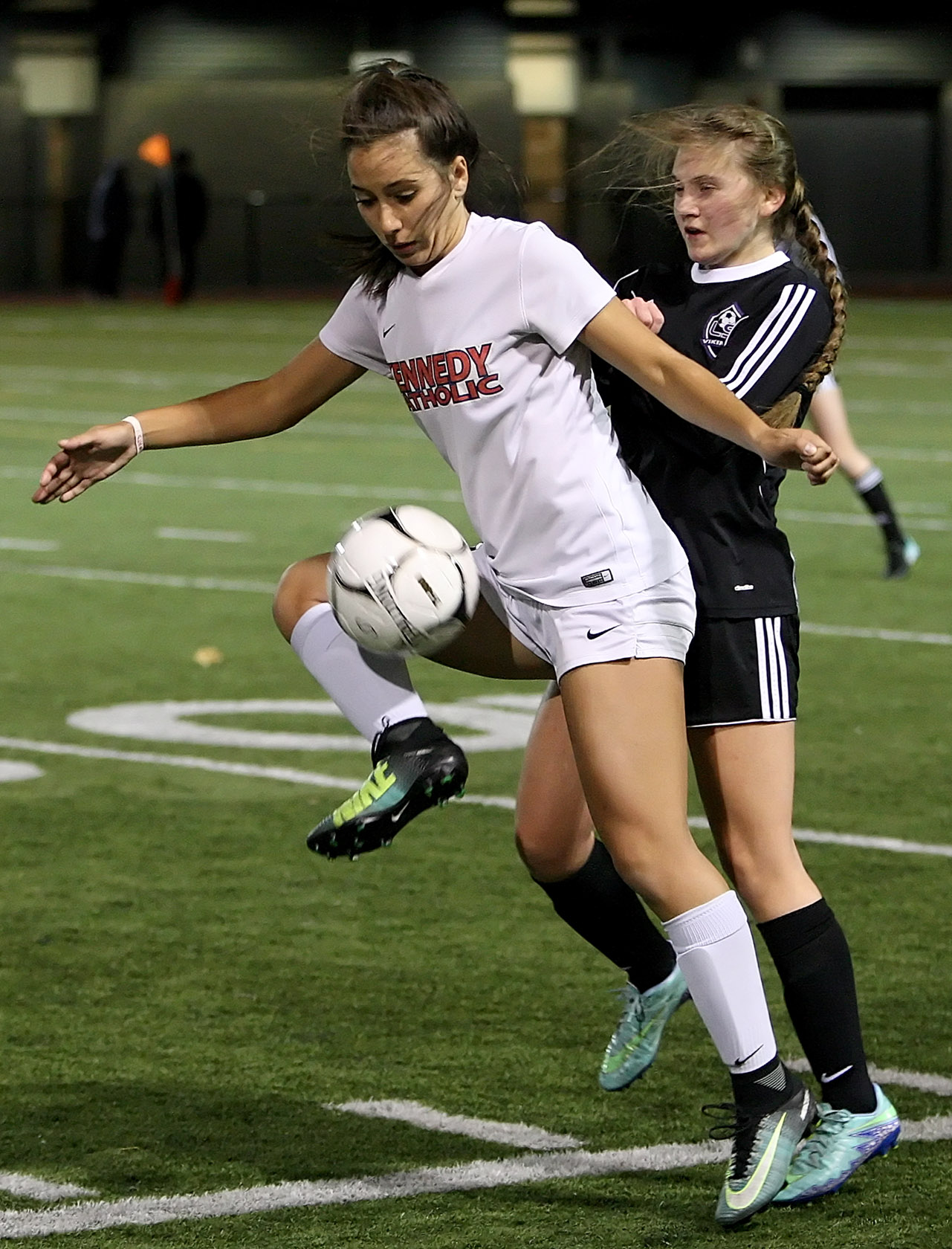 Natalie DeGagne of Kennedy Catholic keeps the ball away from Lake Stevens Jocelyn Lillesaka.