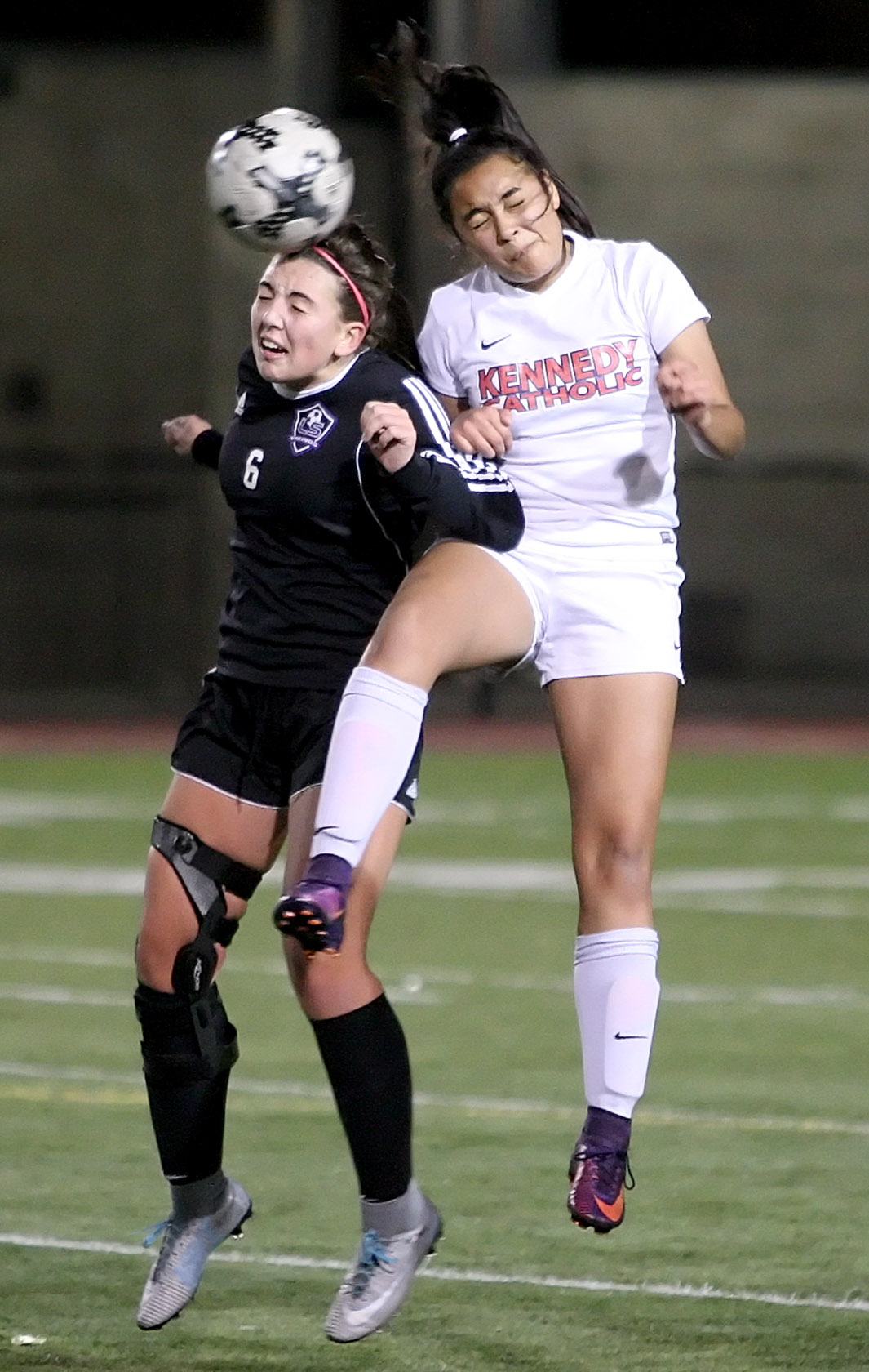 Sam Foly of Lake Stevens and Kennedy Catholics Julie Trejo-Lamphere go for a header.