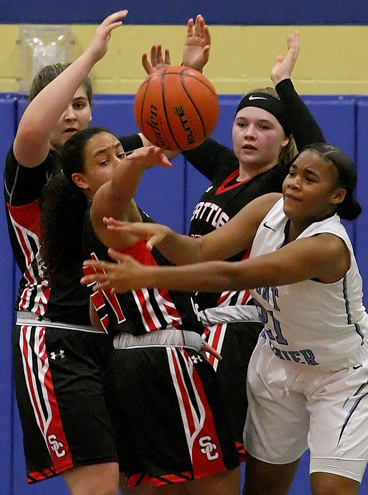 Players watch as the ball is knocked away.  