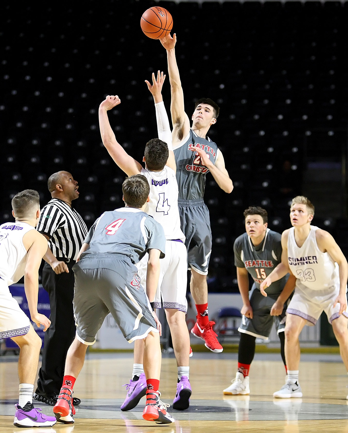 Opening tip has Zac VanderLey of Seattle Christian jumping against Sumner’s Mitchell Wolfe.