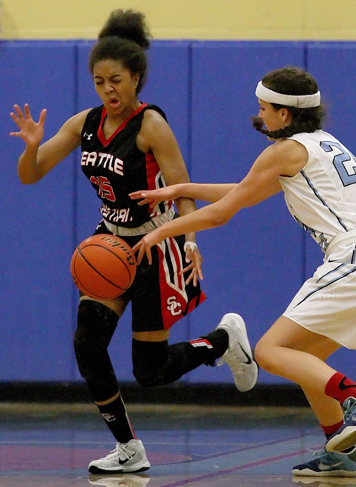 Seattle Christian’s Alexandria Ellis and Mt Rainier’s Jackie Williamson go after a loose ball.