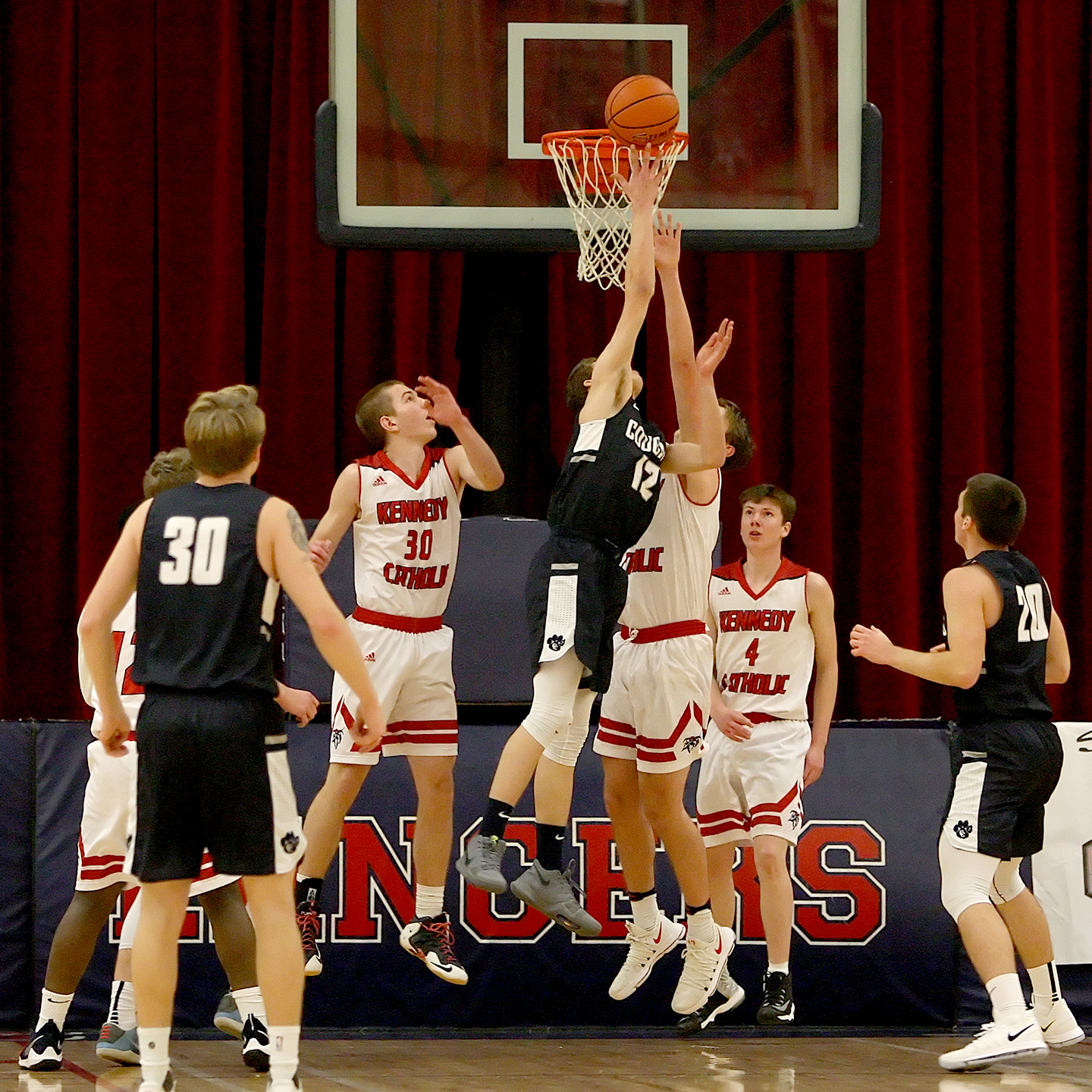 Some rebound action goes on under Cascade Christian's basket.