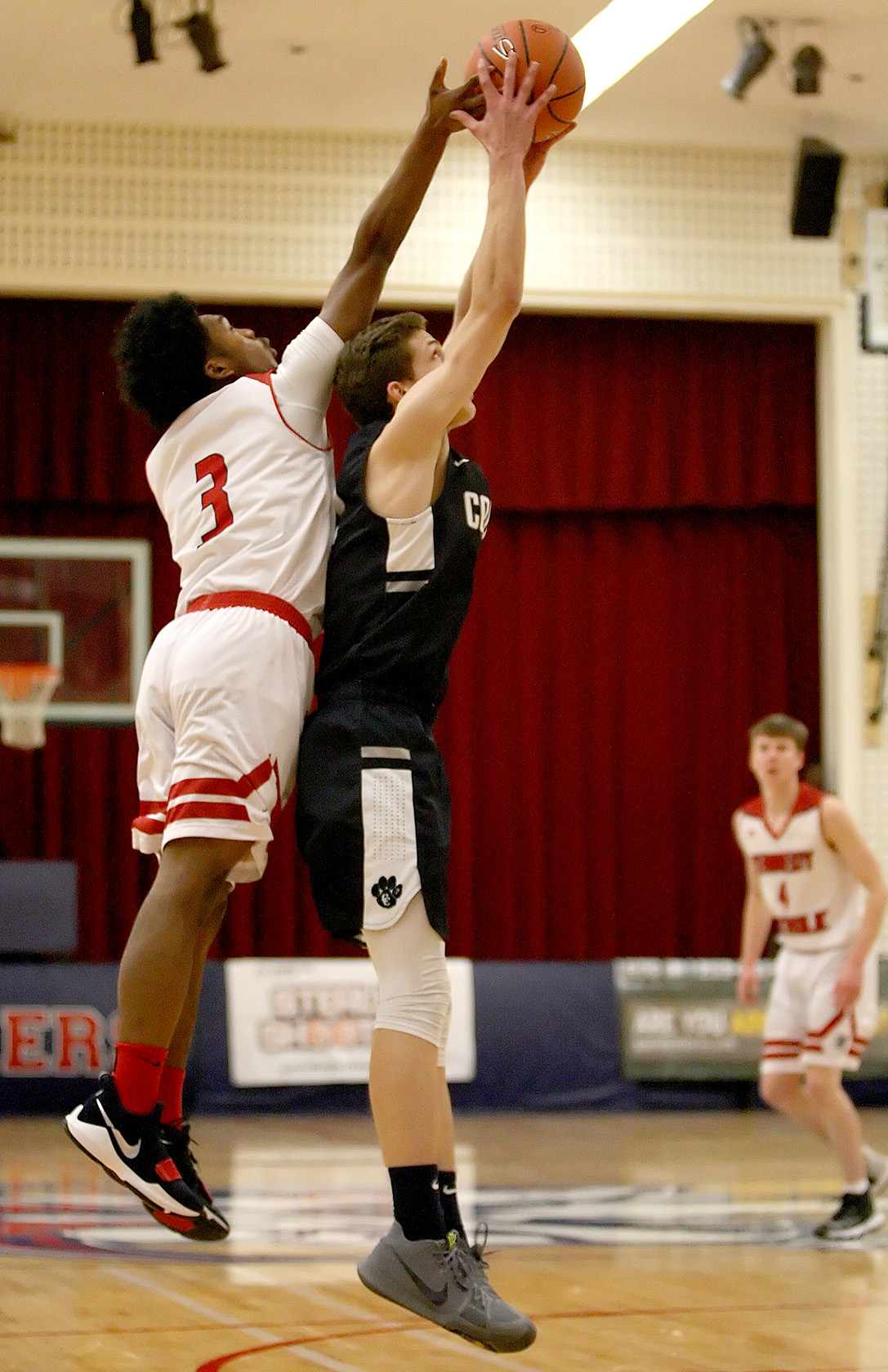 AJ Keys of Kennedy Catholic tries to knock the ball away from Cascade Christian's Nathan Larsen.