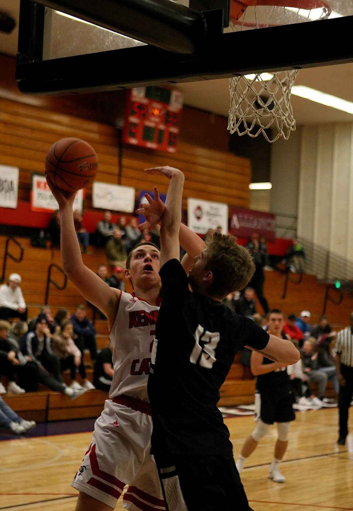 Michael Spitzer of Kennedy Catholic puts up a shot against Cascade Christian's Noah Wilkins.