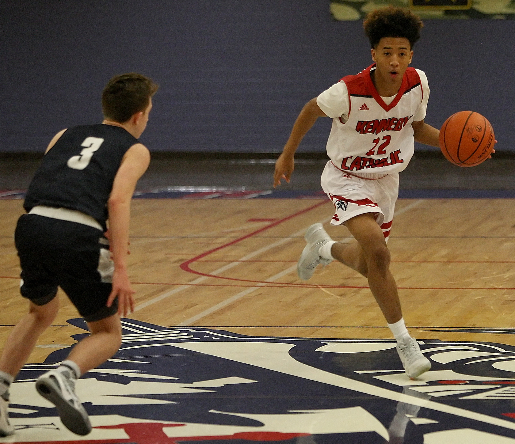 Jack Patsula of Kennedy Catholic brings the ball up court against Cascade Christian's Ben Vandouris.