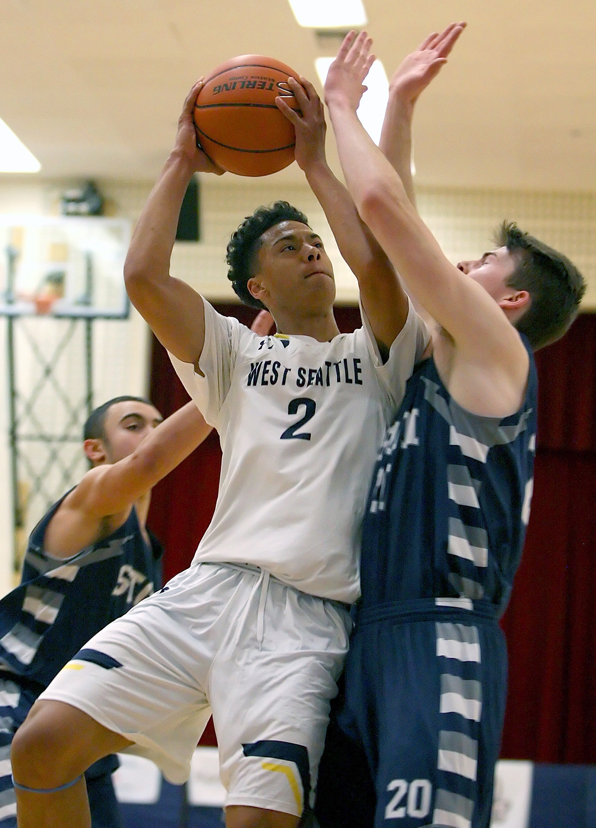 Elijah Nnanabu of West Seattle puts up a shot against defensive pressure from Squalicum's Jacob Hardy.