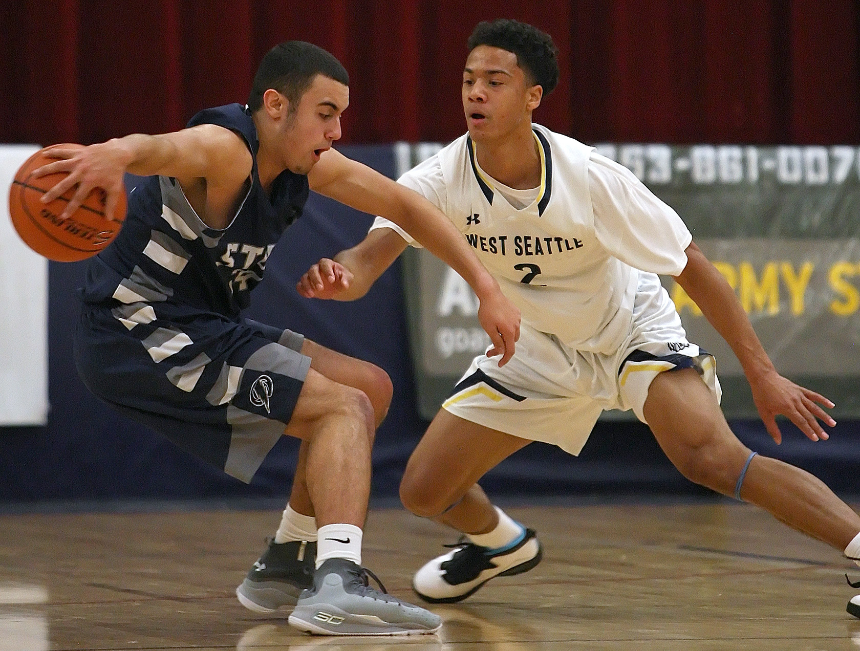 Elijah Nnanabu of West Seattle puts up a shot against defensive pressure from Squalicum's Jacob Hardy.