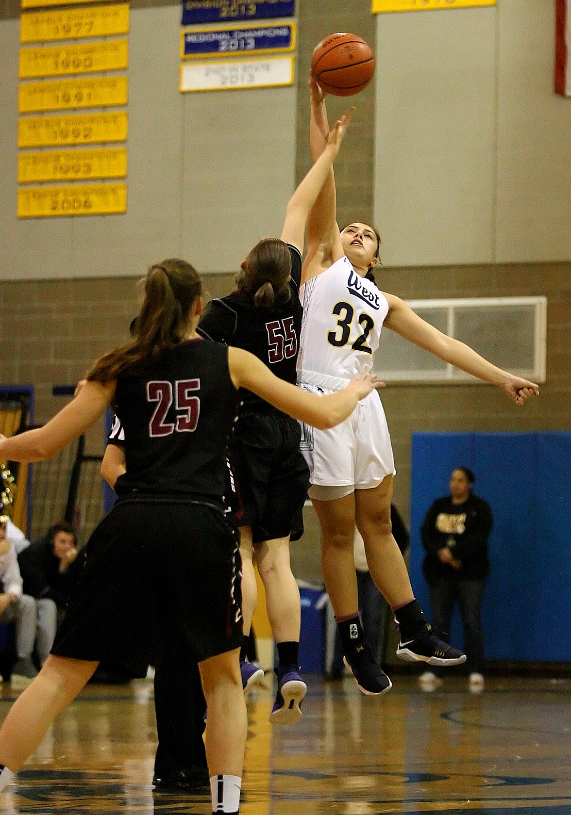 Opening tip off has Megan Fiso of West Seattle jumping against Lakeside's Grace Harrington.