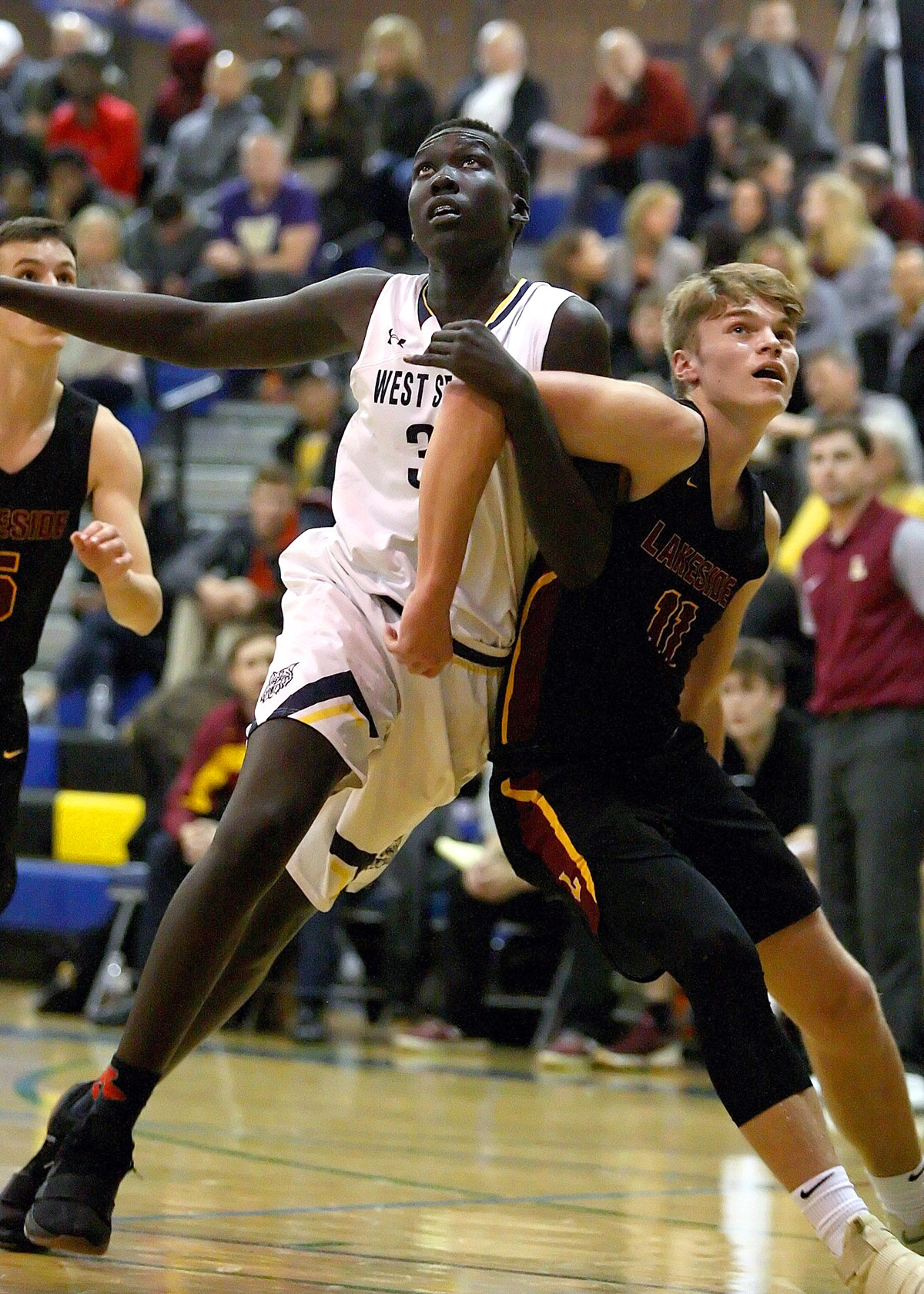 Maar Rambang of West Seattle tangles arms with Lakeside's Max Knight on a rebound.