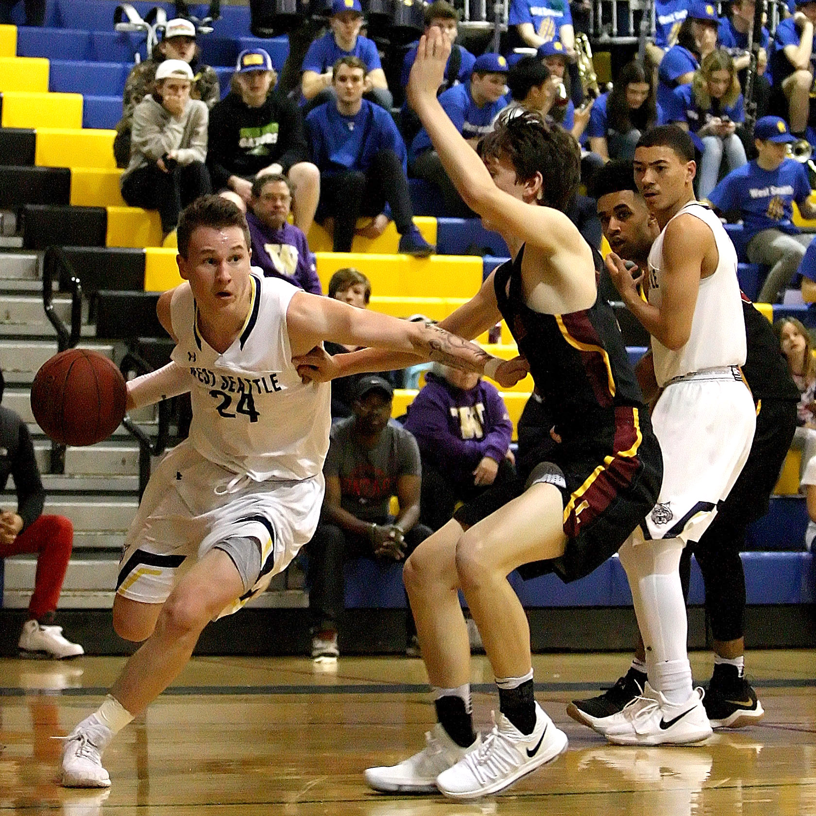 Simon Harris of West Seattle dribbles baseline against the defensive pressure of Lakeside's Robert Breyer.