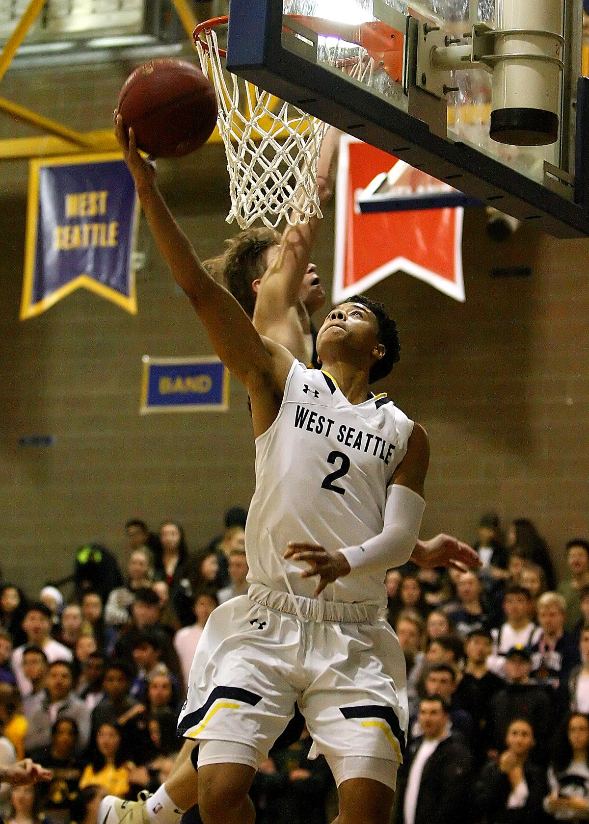 Elijah Nnanabu of West Seattle makes a reverse layup against Lakeside's Max Knight.