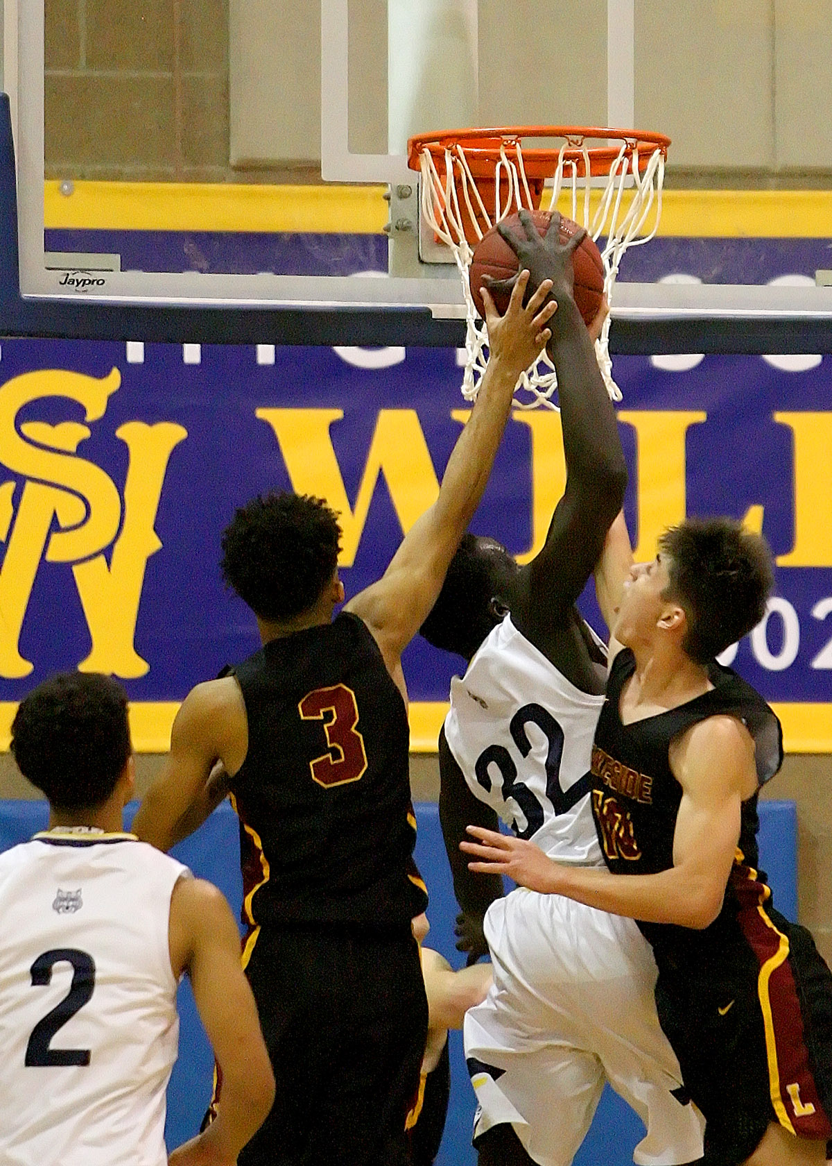 Maar Rambang of West Seattle fights for a rebound against Lakeside's Omahre Gratton and William Barton.