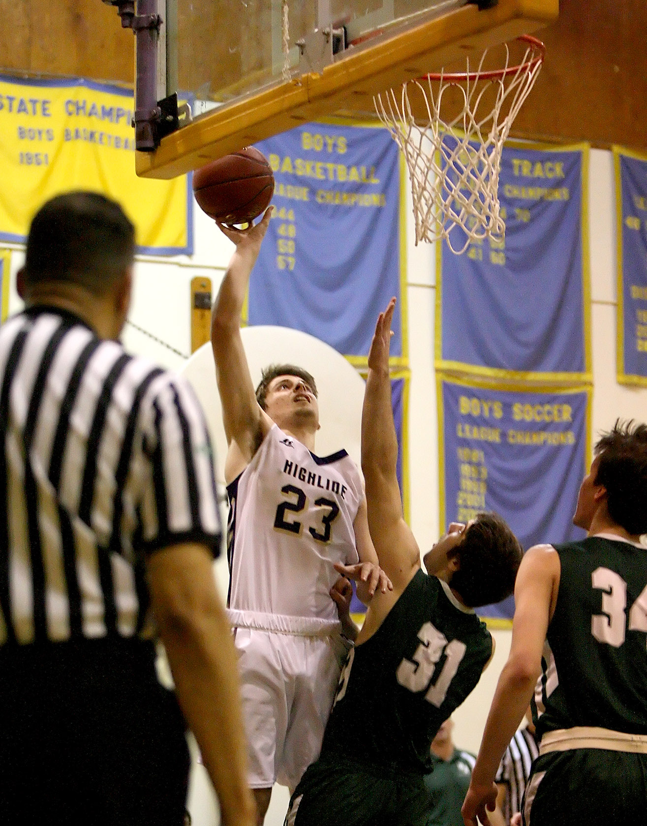 Nick Hovland of Highline shoots over the defensive pressure of Port Angeles Garrett Edwards.