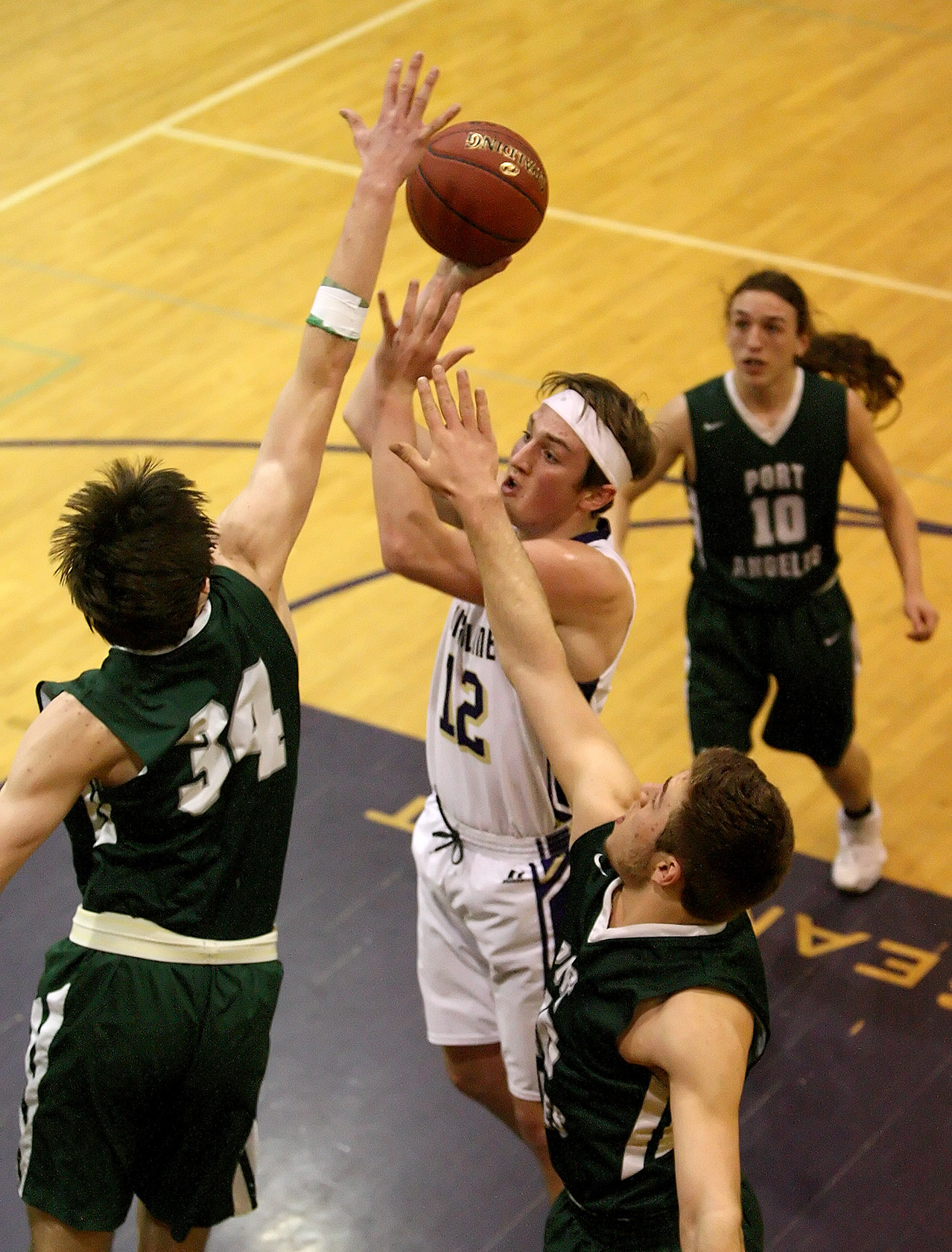 Jack Burcham of Highline put up a shot against Port Angeles Liam Clark.