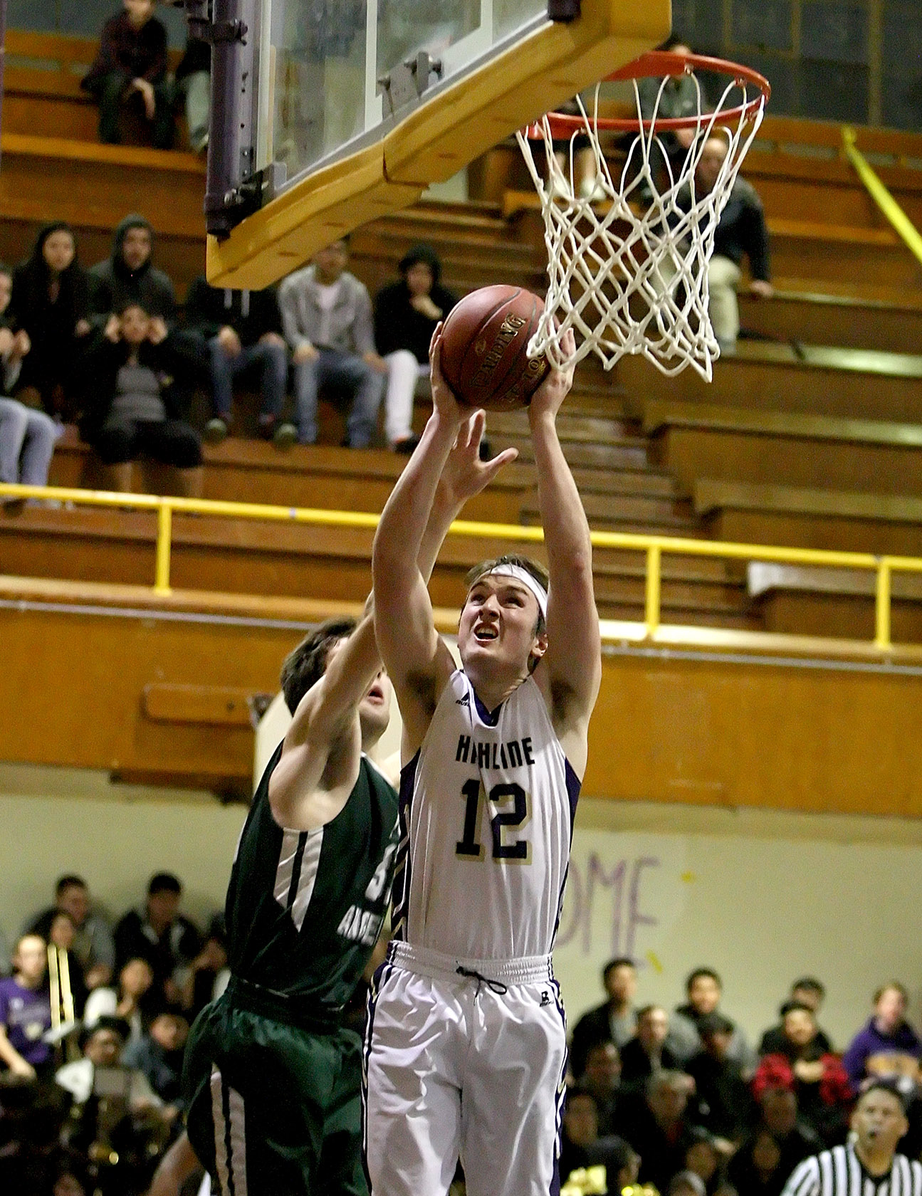 Jack Burcham of Highline scores under the basket.