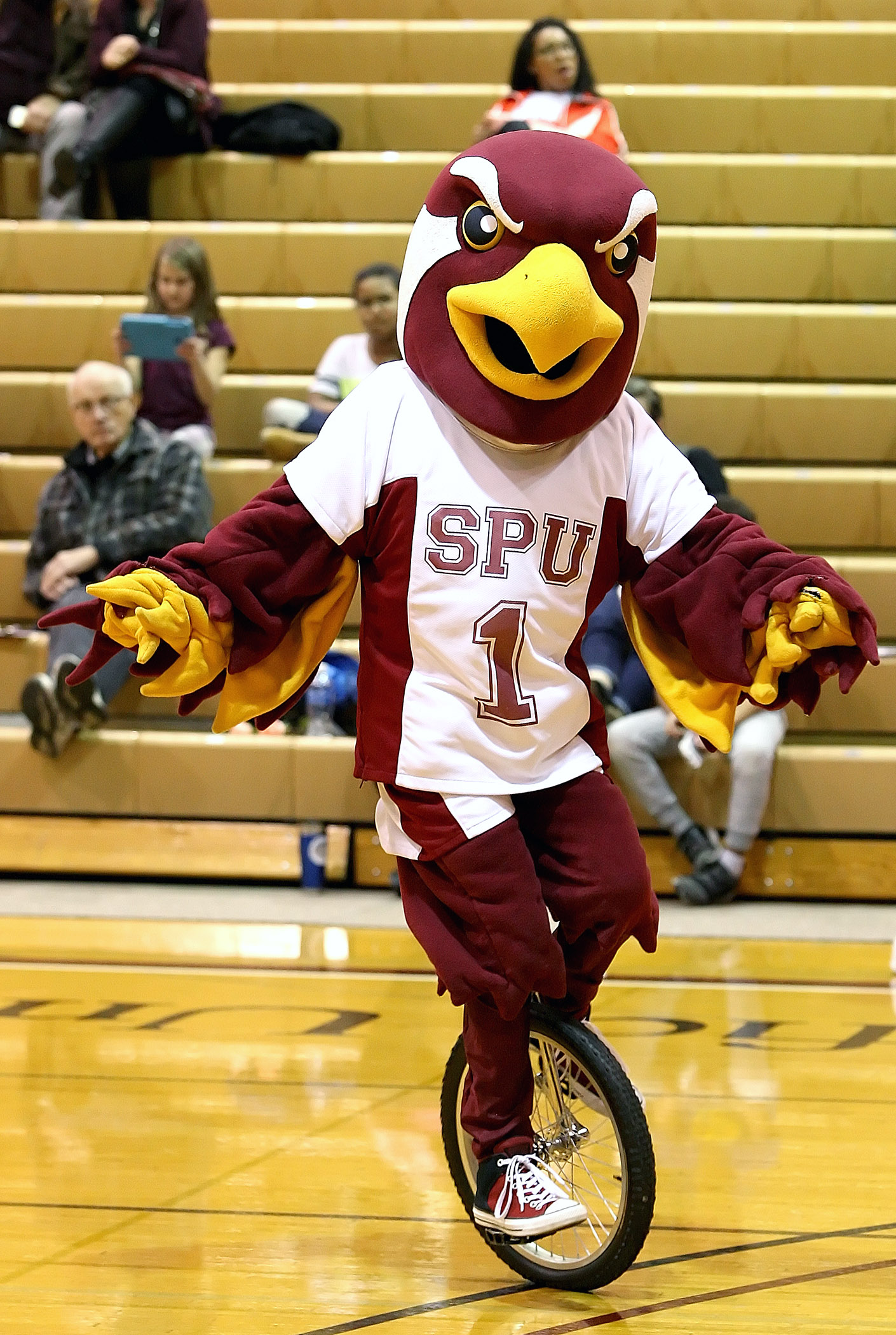 Seattle Pacific’s mascot, TALON, entertains the fans by riding a unicycle at halftime.  