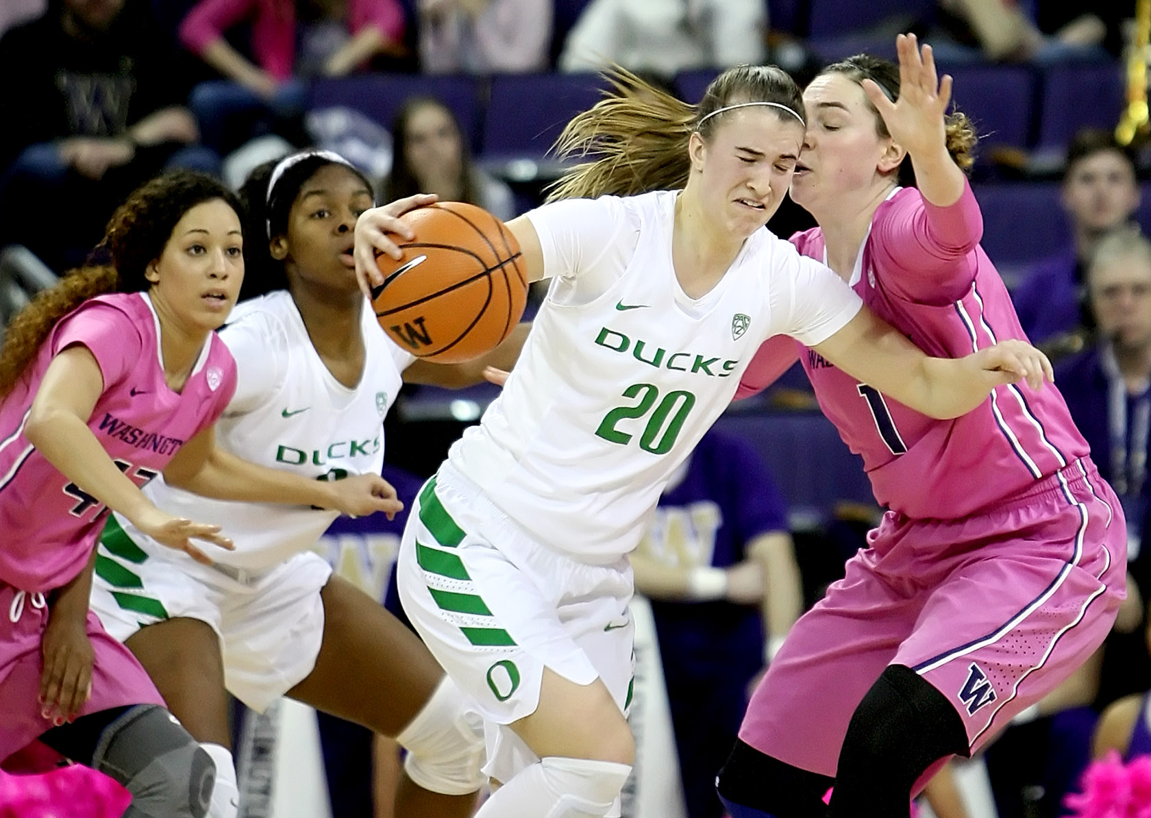 Sabrina Ionescu of Oregon dribbles into Washington's Hanna Johnson.