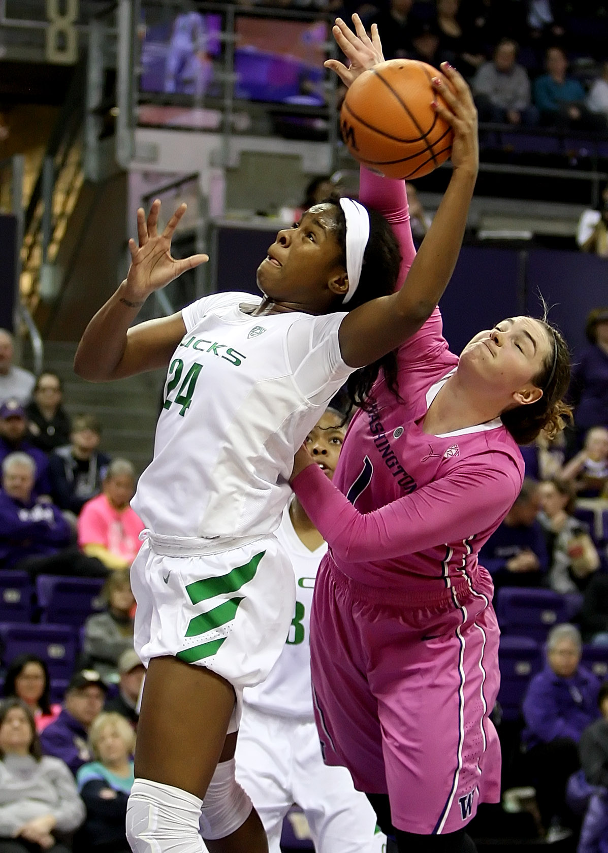 Ruthy Hebard of Oregon and Washington's Hannah Johnson fight for a rebound.