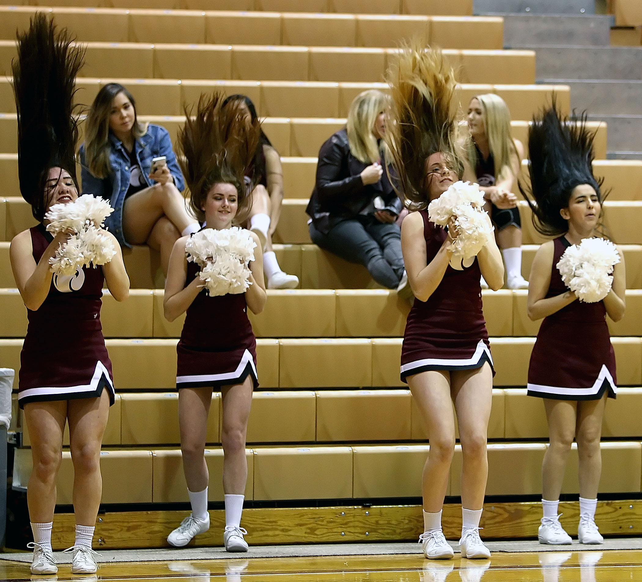 Some of the Seattle Pacific cheerleaders have their hair rise to the occasion.  
