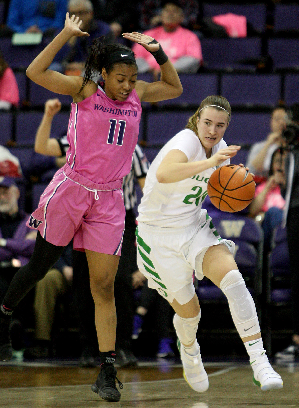 Sabrina lonescu of Oregon is fouled by Washington's Kierra Collier dribbling up court.