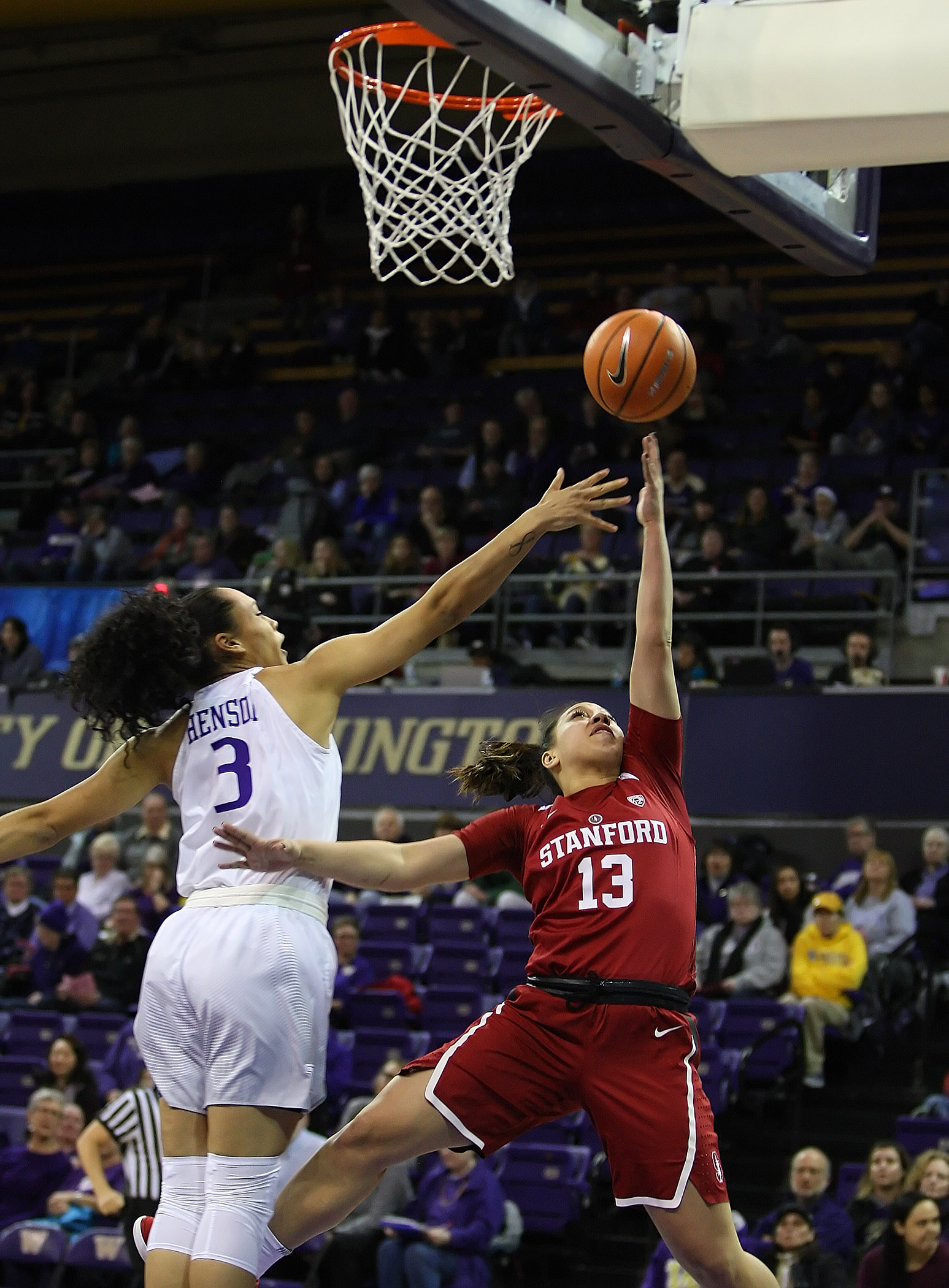 Marta Sniezek of Stanford puts up a shot against the defensive pressure from Washington’s Mia-Loni Henson.