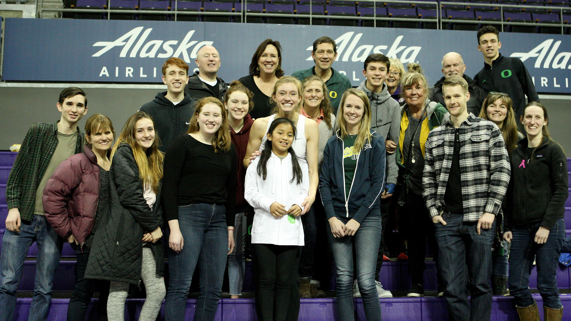 Lydia Giomi of Oregon poses for a photo with friends and family after the game.