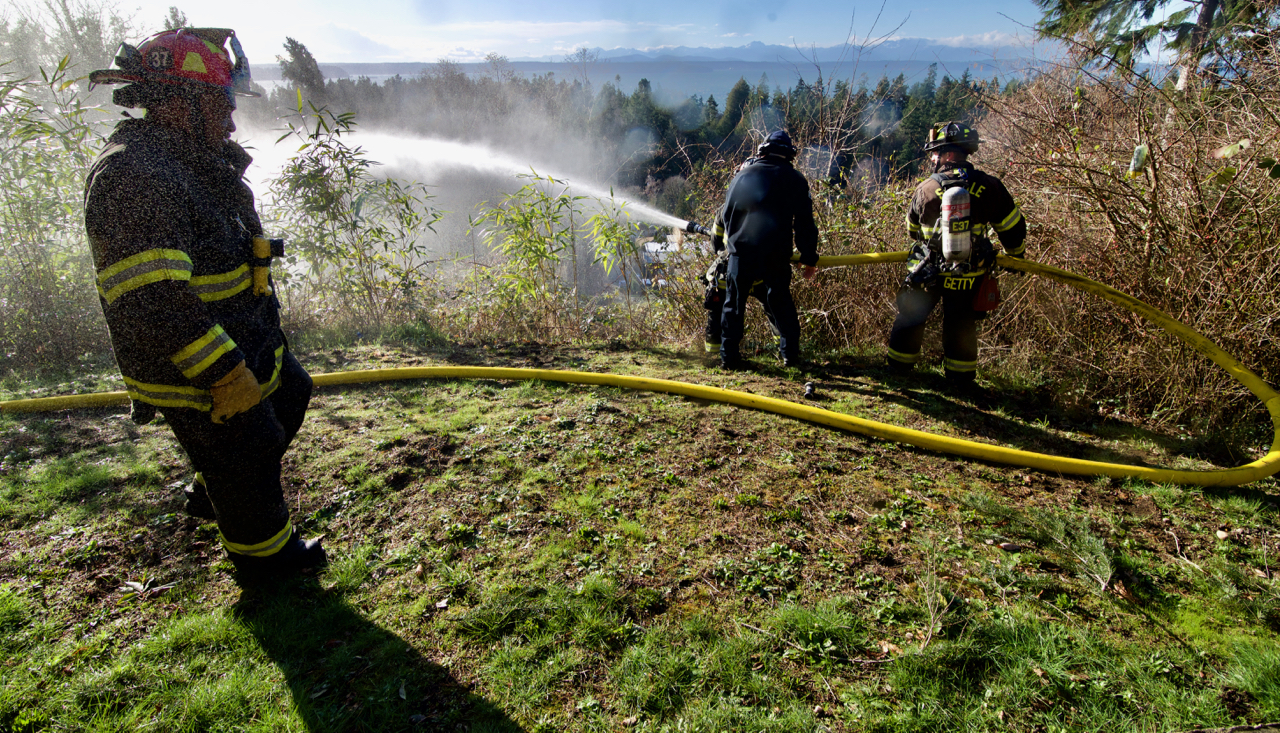 firefighters battle brush fire