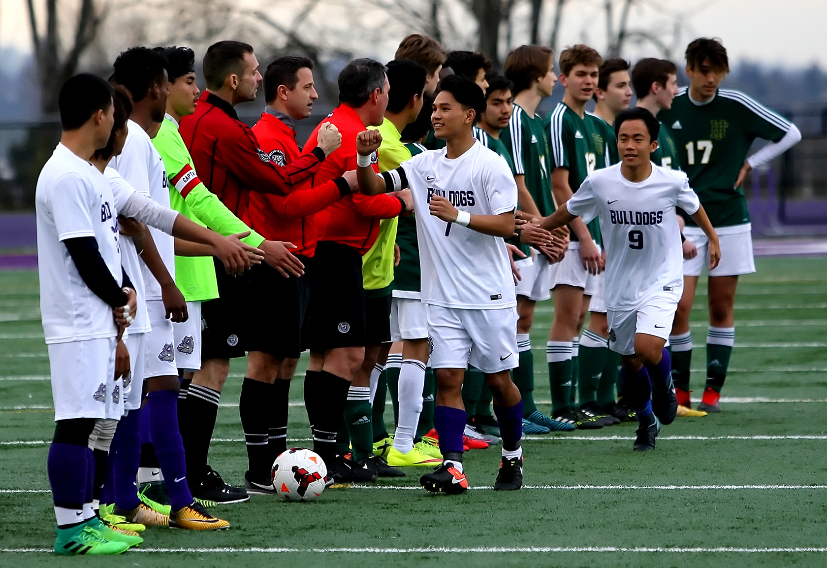 Before the match Foss and Foster players and the referees great each other.