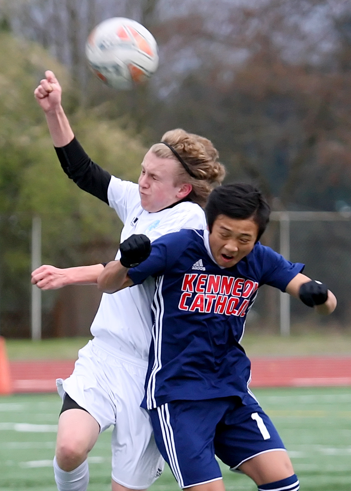 Jake Sylvester of Mt. Rainier and Kennedy Catholic's Julius Nguyen collide trying to head the ball.