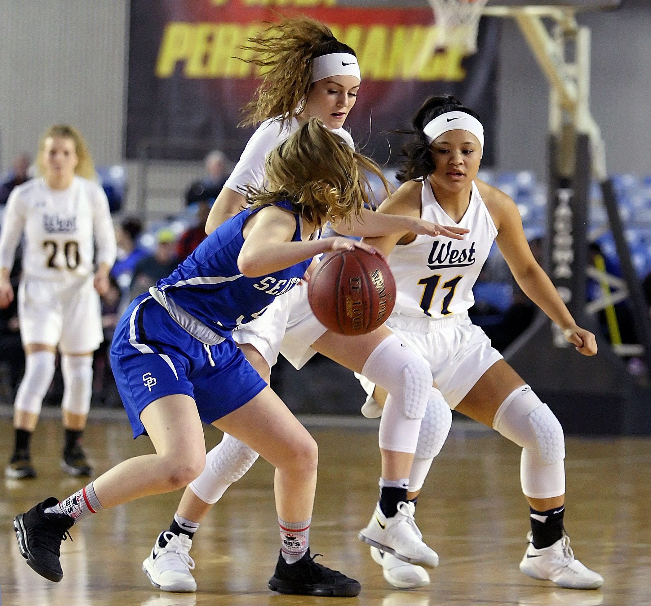 Kelsey Lenzie and Jasmine Gayles of West Seattle double team Seattle Preps Helen Sauvage near mid-court.