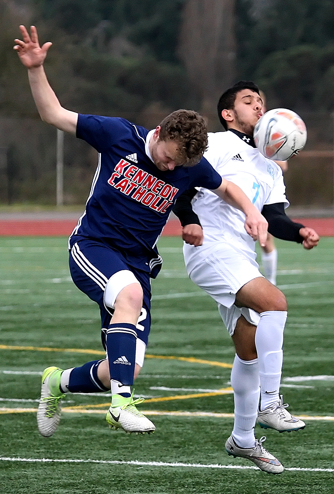 Mustafa Alobaidi of Mt. Rainier chins the ball with pressure from Kennedy Catholic's Luke Tolton.