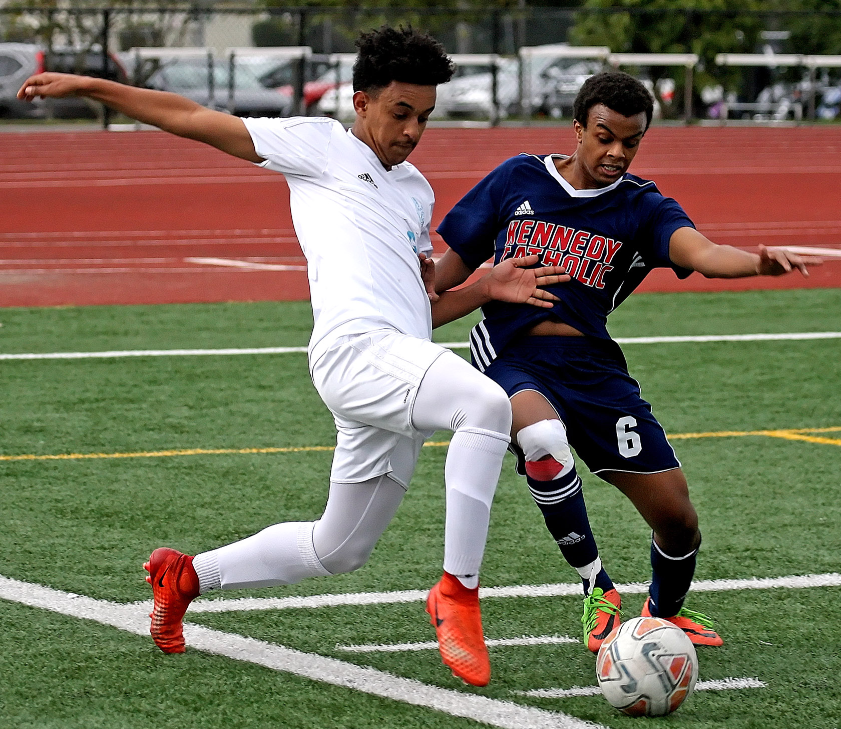 Michael Fikadu of Mt. Rainier and Kennedy Catholic's Phanuel Araya go for the ball.