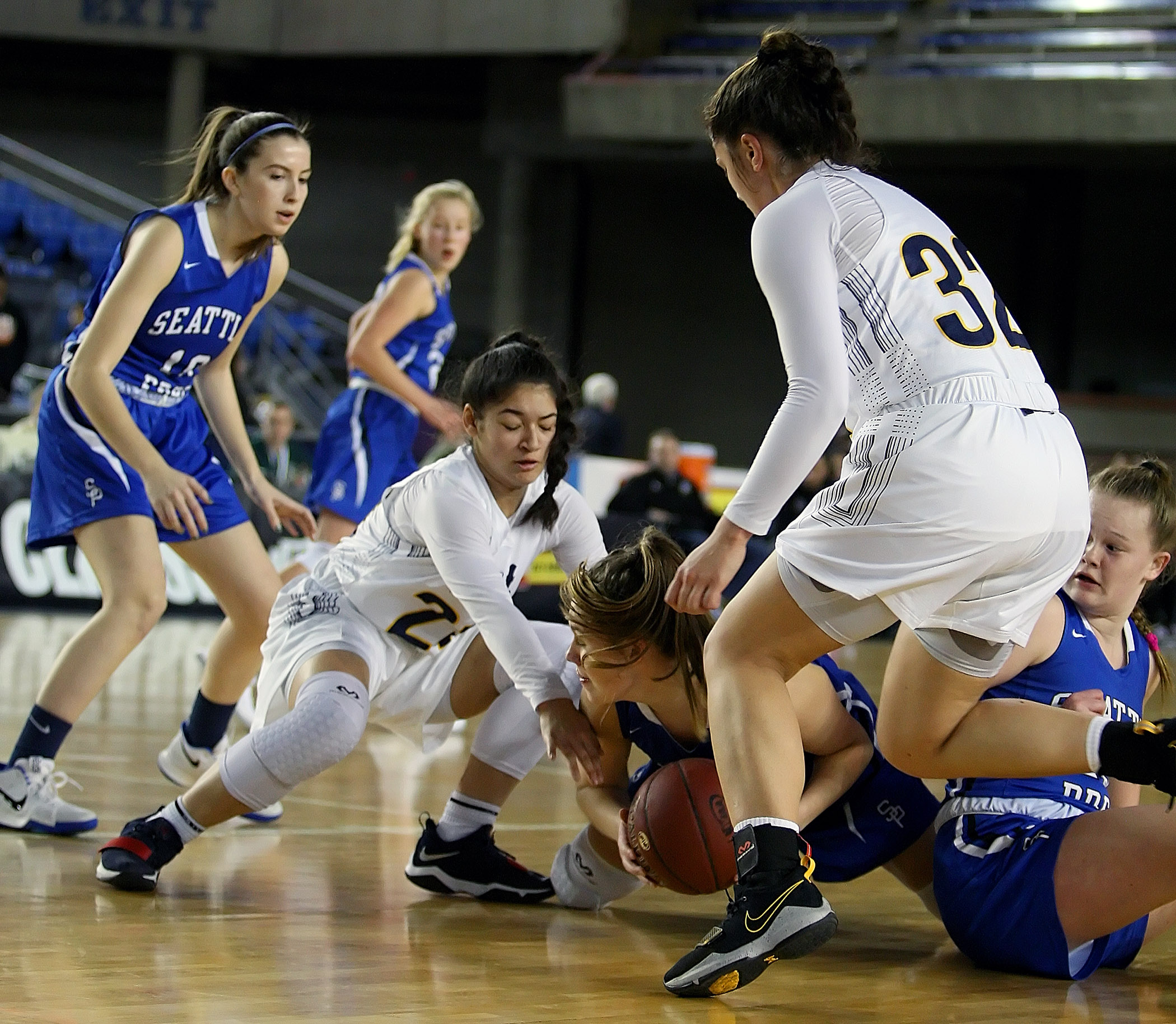 Juliana Horne and Megan Fiso of West Seattle try to take the ball away from Seattle Preps Lily Teders.