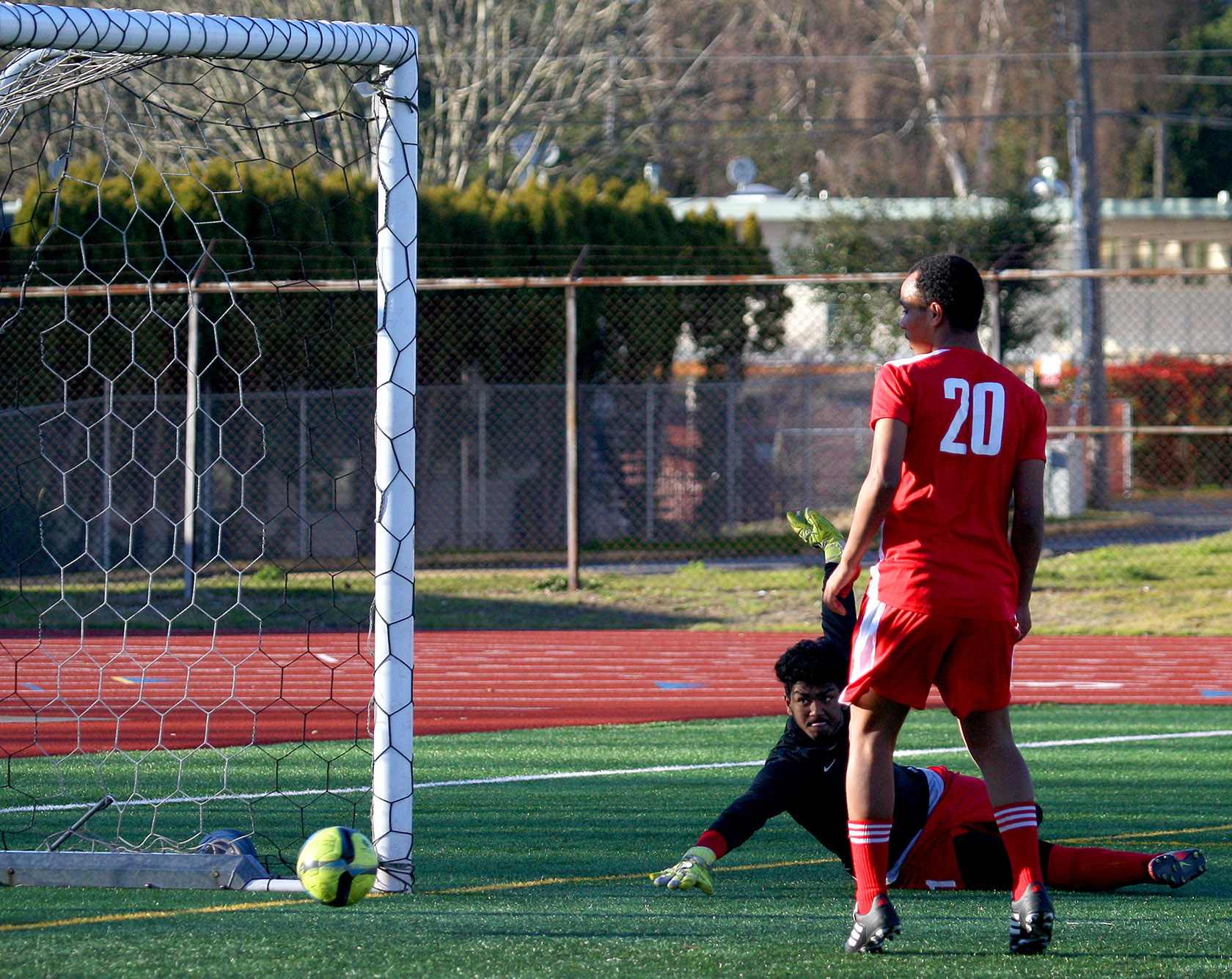 The ball rolls into the goal as Evergreen scores their first goal at 24:54 in the first half against Tyee's goalie Gurpall Singh.