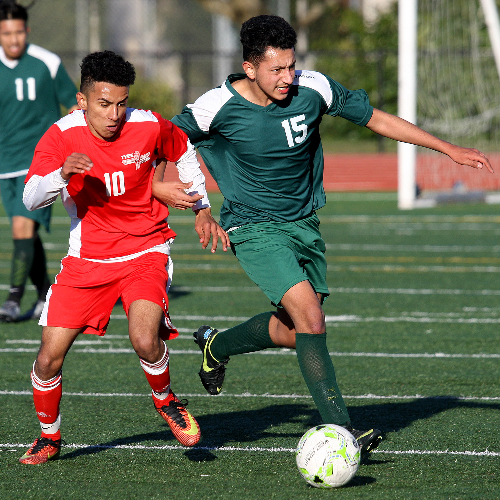 Samuel Tessema of Tyee and Evergreen's Elias Robles chase down the ball.