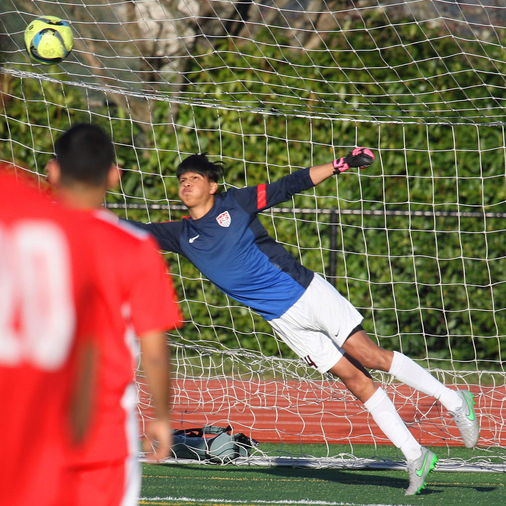 Tyee scores their first goal against Evergreen's goalie Samuel Serrano-Perez. 