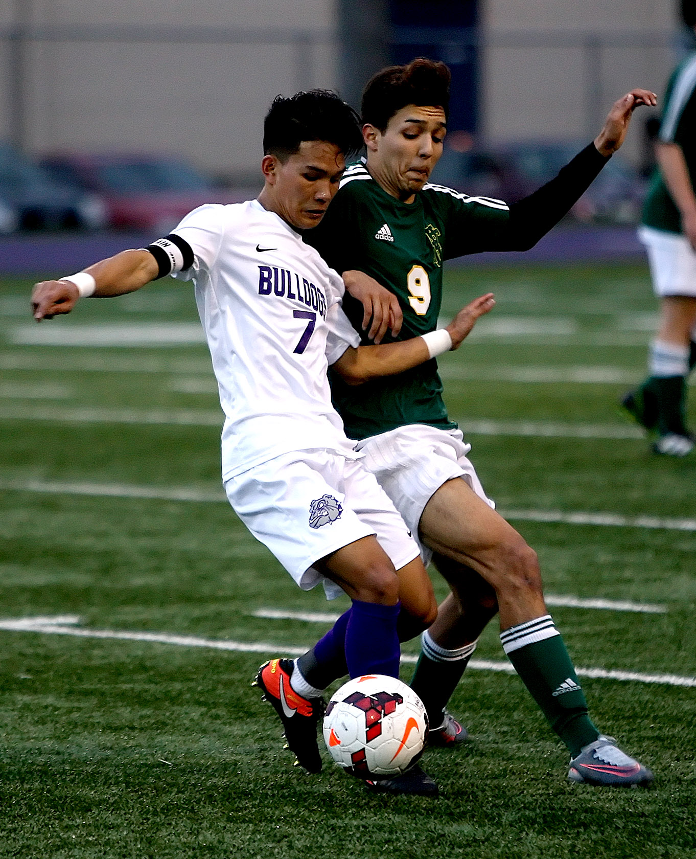 Bik Ceu of Foster gets his foot on the ball against the pressure from Foss's Jacob Rodriguez.