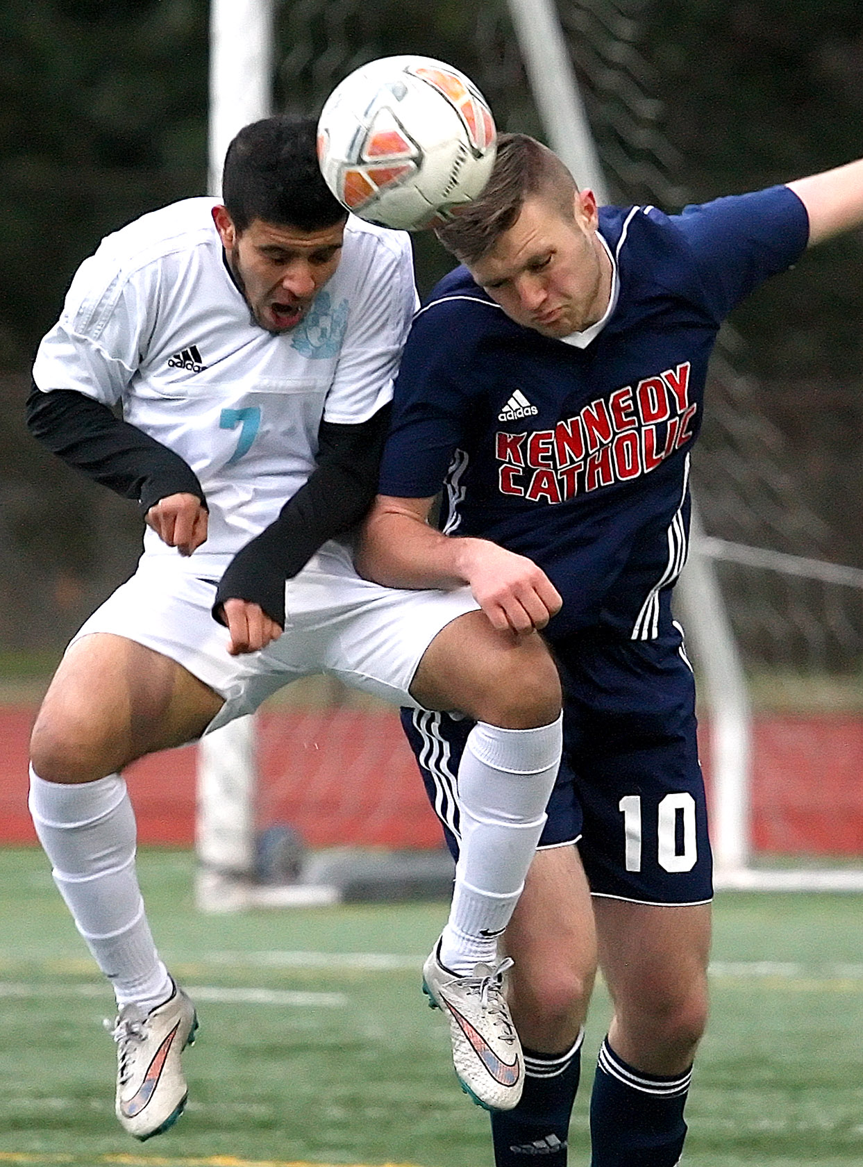 Mustafa Alobaidi of Mt. Rainier and Kennedy Catholic's Aiden Berg both head the ball.