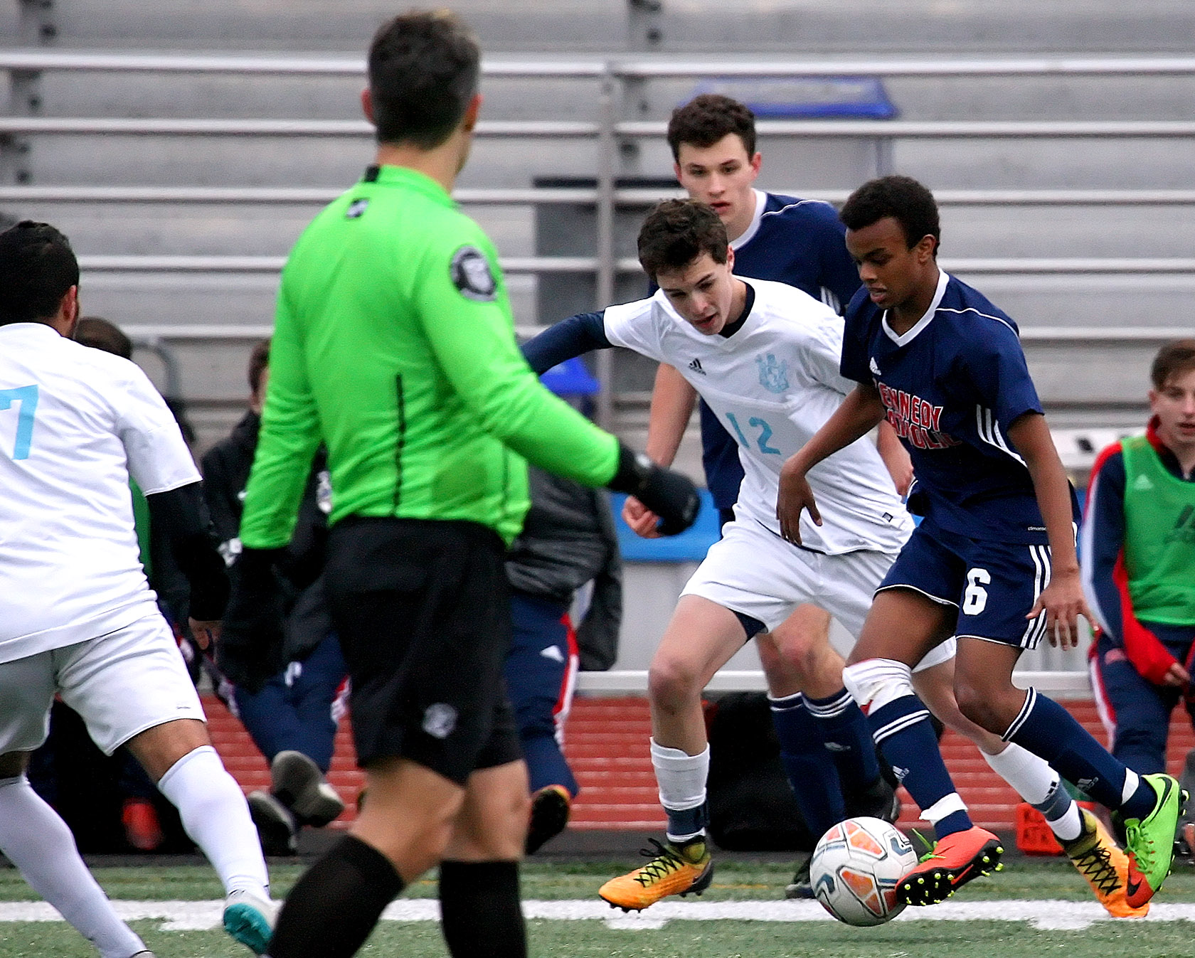 Phanuel Araya of Kennedy Catholic brings the ball up the sidelines against defensive pressure from Mt. Rainier's Colby Nelson.