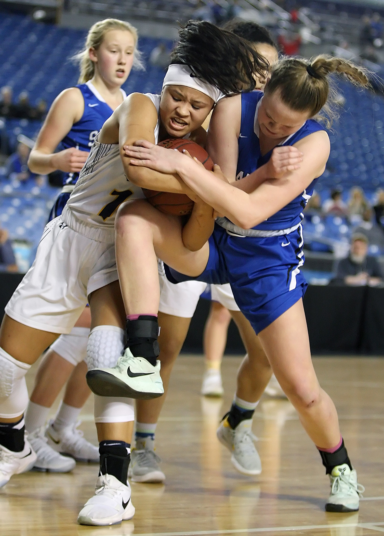 Jasmine Gayles of West Seattle and Seattle Preps Molly Moffitt fight for the ball.
