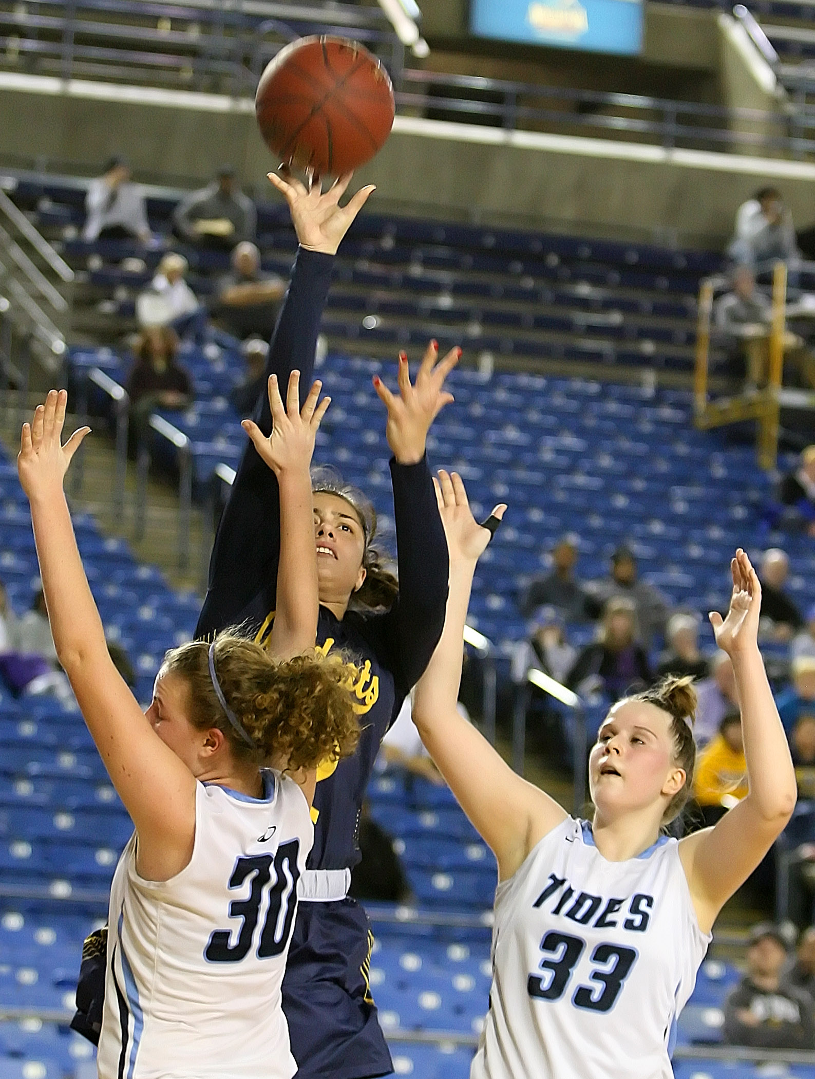 Meghan Fiso of West Seattle makes a jump shot against defensive pressure from Gig Harbors Grace Neil and Maddie Willett.