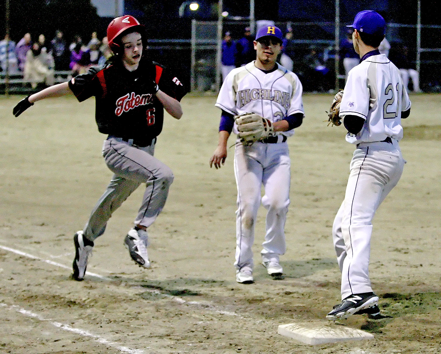 Jeremiah France of Highline touches 1st base just before Tyee's Jeremiah France reaches the bag.