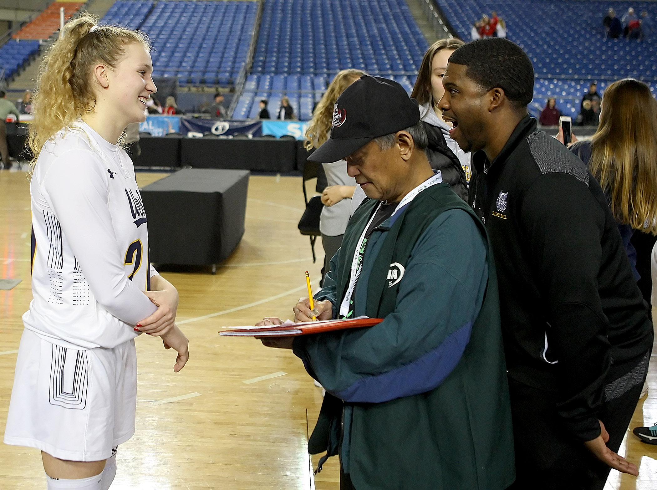 During an interview with West Seattle's Grace Sarver, coach Darnell Taylor jokingly harasses her, as he hides behind Westside Seattle's sports writer, Gerardo Bolong.