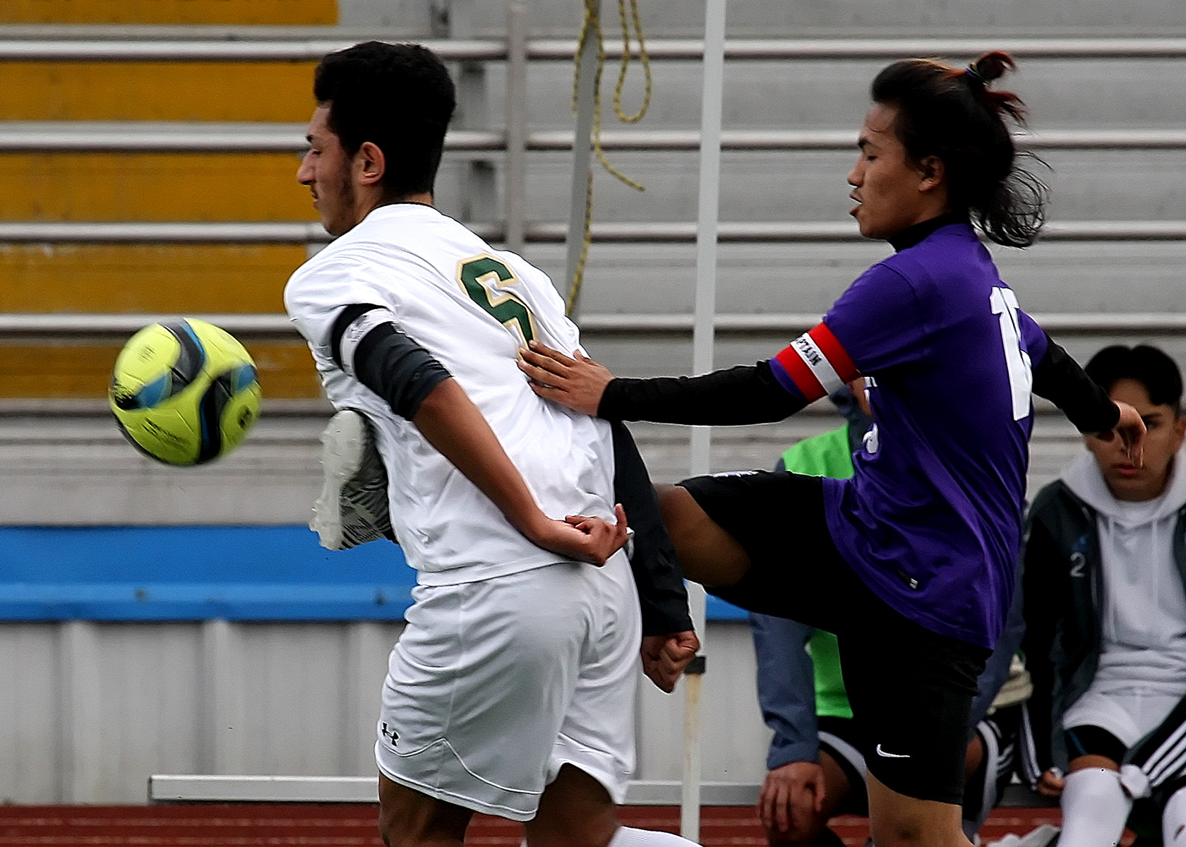 James Mung of Foster kicks Evergreen's Elias Robles in the chest aiming for the ball.