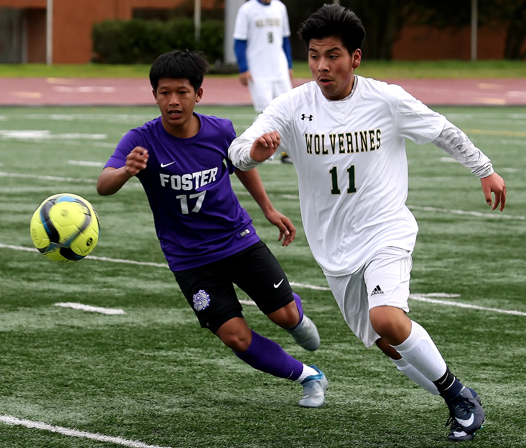 Bond, James Bond of Foster and Evergreen's Christian Rosas chase after the ball.