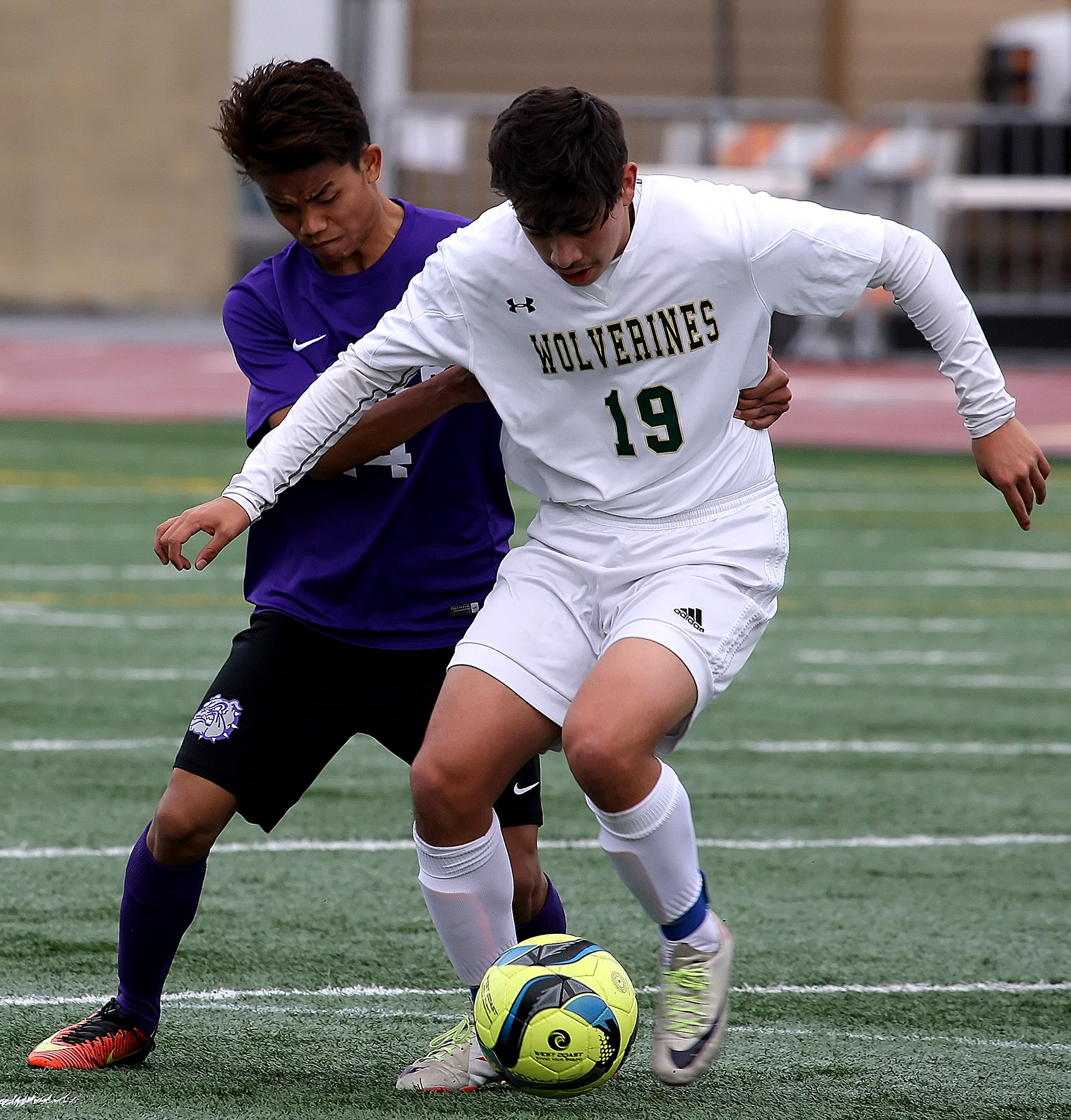 Brian Chicas of Evergreen tries to keep the ball away from Foster's Kum Hnin.