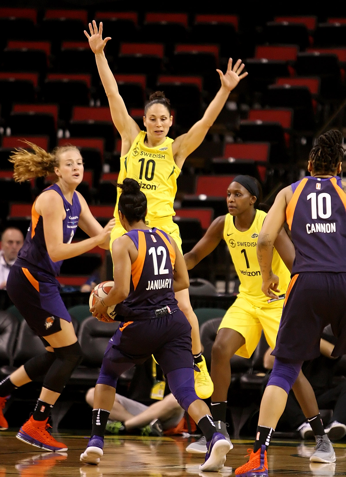 Sue Bird of the Storm goes airborne to disrupt a pass by the Mercury's Briann January. 