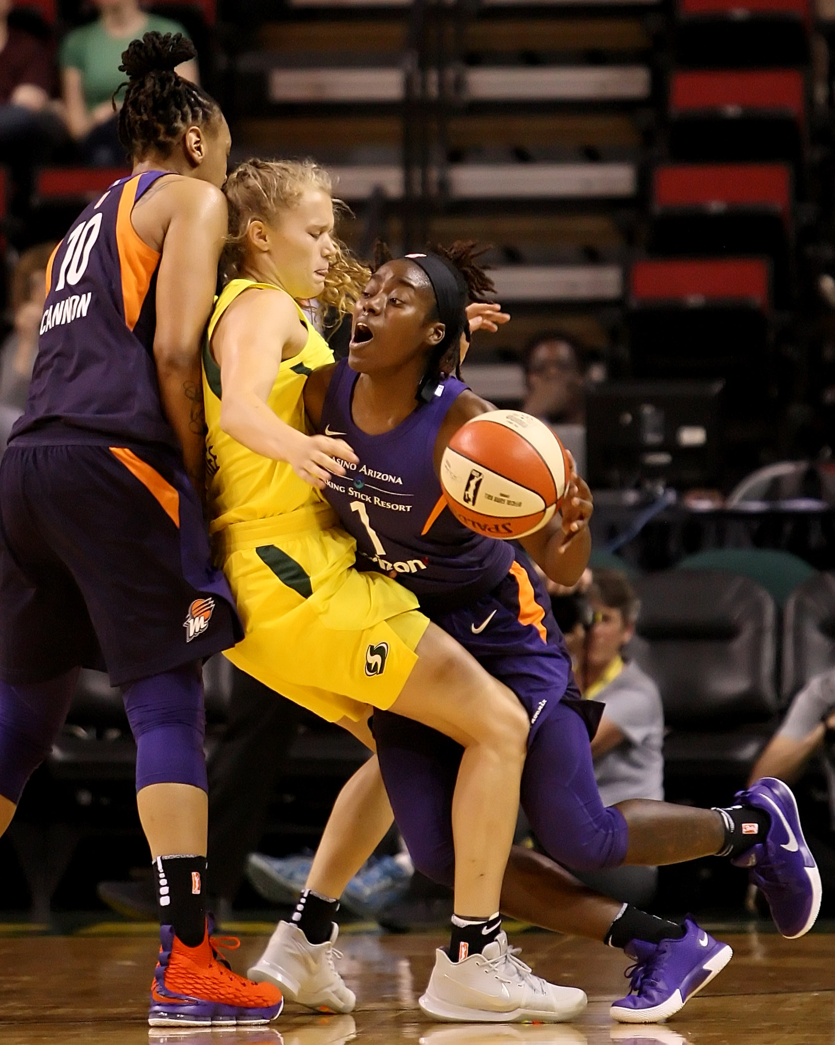 Brittany McPhee of the Storm gets sandwiched between Mercury players Emma Cannon and Imani Wright.